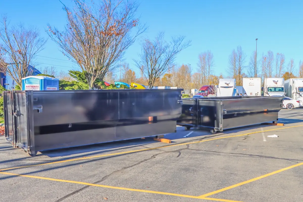 Professional dumpster rental service with roll-off container on residential driveway in Forest Grove